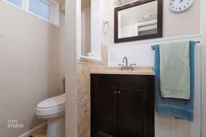 Bathroom with vanity and wainscoting, 3/4 bath. Shower not pictured.