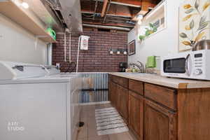 Separate entrance welcome room! Small kitchenette in laundry area and light tile patterned floors. Could be a fully functional kitchen with a few upgrades.
