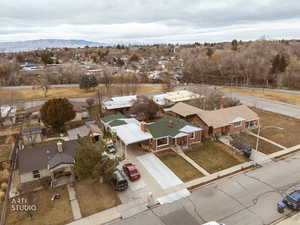 Aerial perspective of suburban area Provo River Trail and park. New concrete driveway and repaired drive approach.