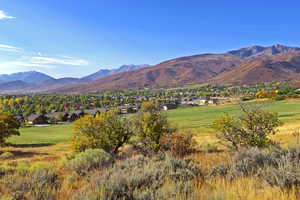 View of mountain backdrop featuring nearby suburban area