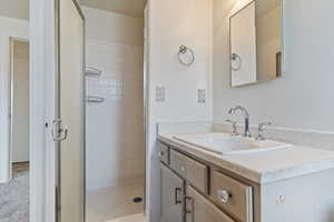 Full bath with vanity and a shower stall