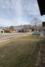 View of green lawn with a mountain view