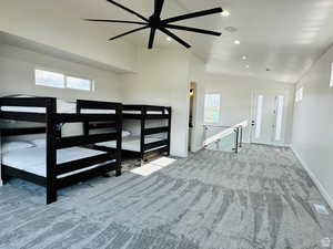 Unfurnished room with vaulted ceiling, ceiling fan, plenty of natural light, light colored carpet, and recessed lighting