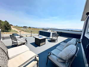 View of patio / terrace with an outdoor living space with a fire pit and a mountain view