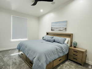 Carpeted bedroom with baseboards and a ceiling fan