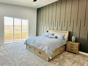 Bedroom featuring access to exterior, light carpet, recessed lighting, an accent wall, and ceiling fan
