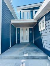 Doorway to property featuring a porch
