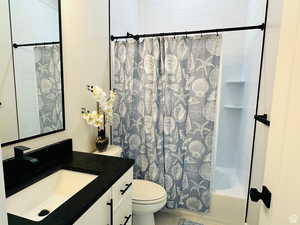 Full bathroom featuring vanity and shower / tub combo with curtain