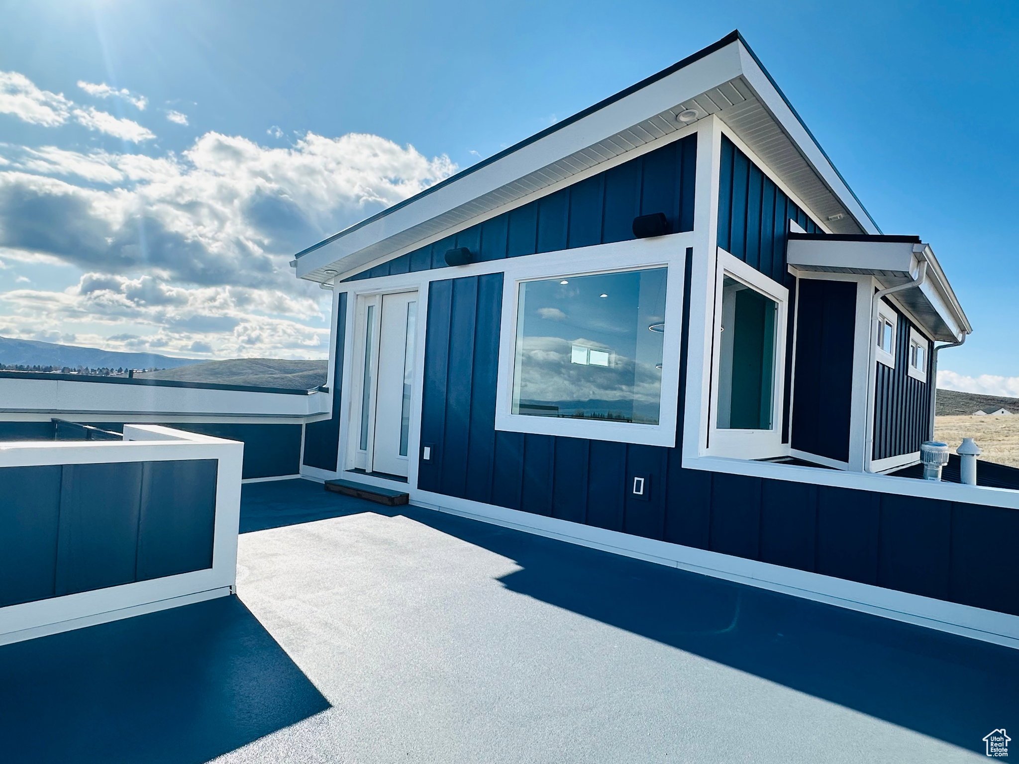 View of side of home with board and batten siding and a patio