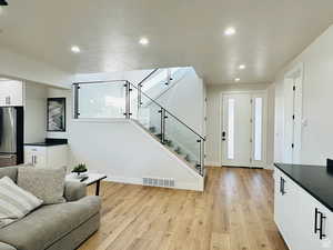 Living area featuring light wood-style floors and recessed lighting