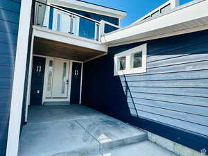 Doorway to property featuring covered porch