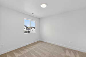 Unfurnished room featuring baseboards and carpet flooring