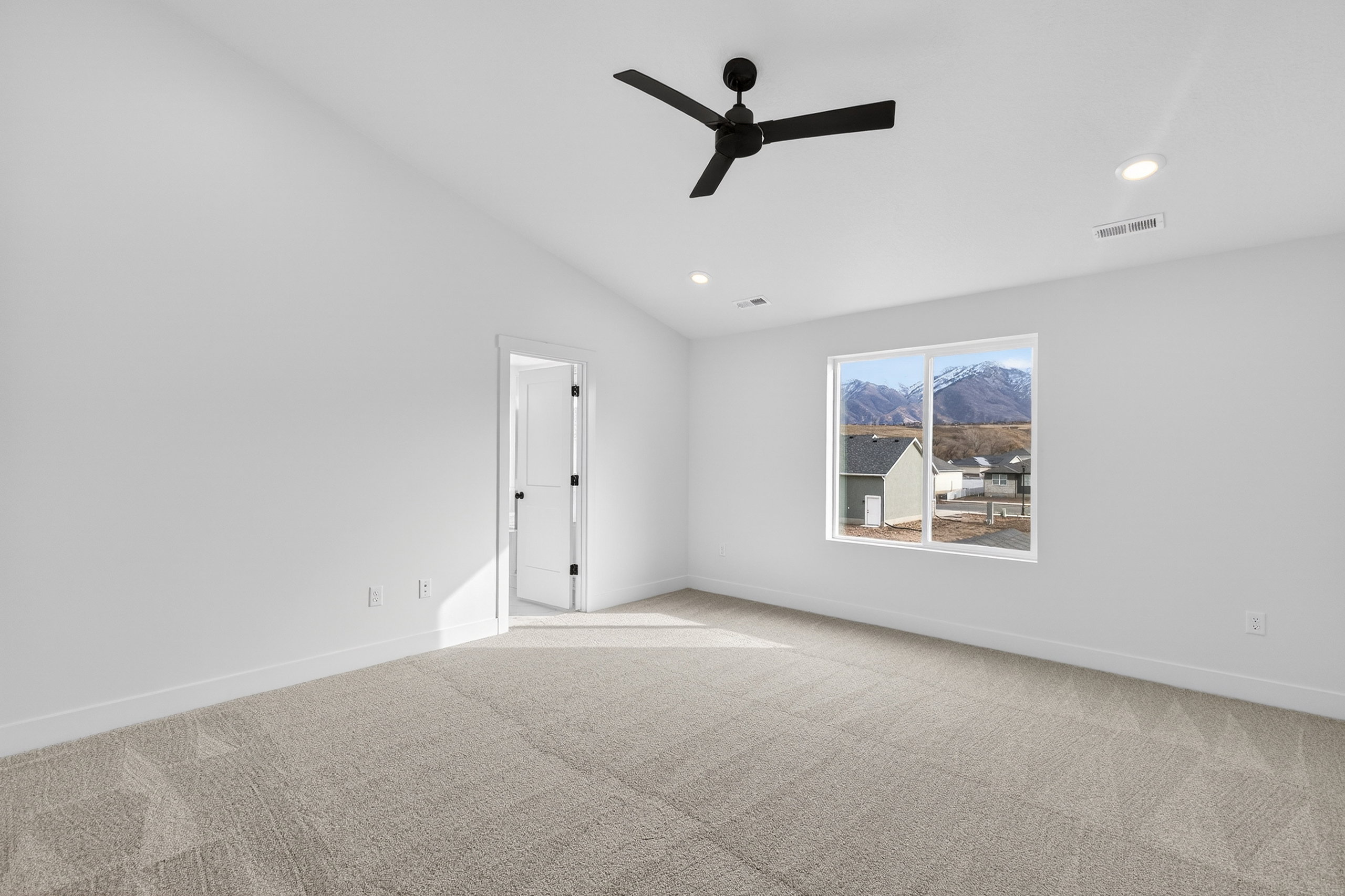 Carpeted empty room with ceiling fan, lofted ceiling, and recessed lighting