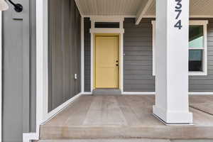 Property entrance with covered porch