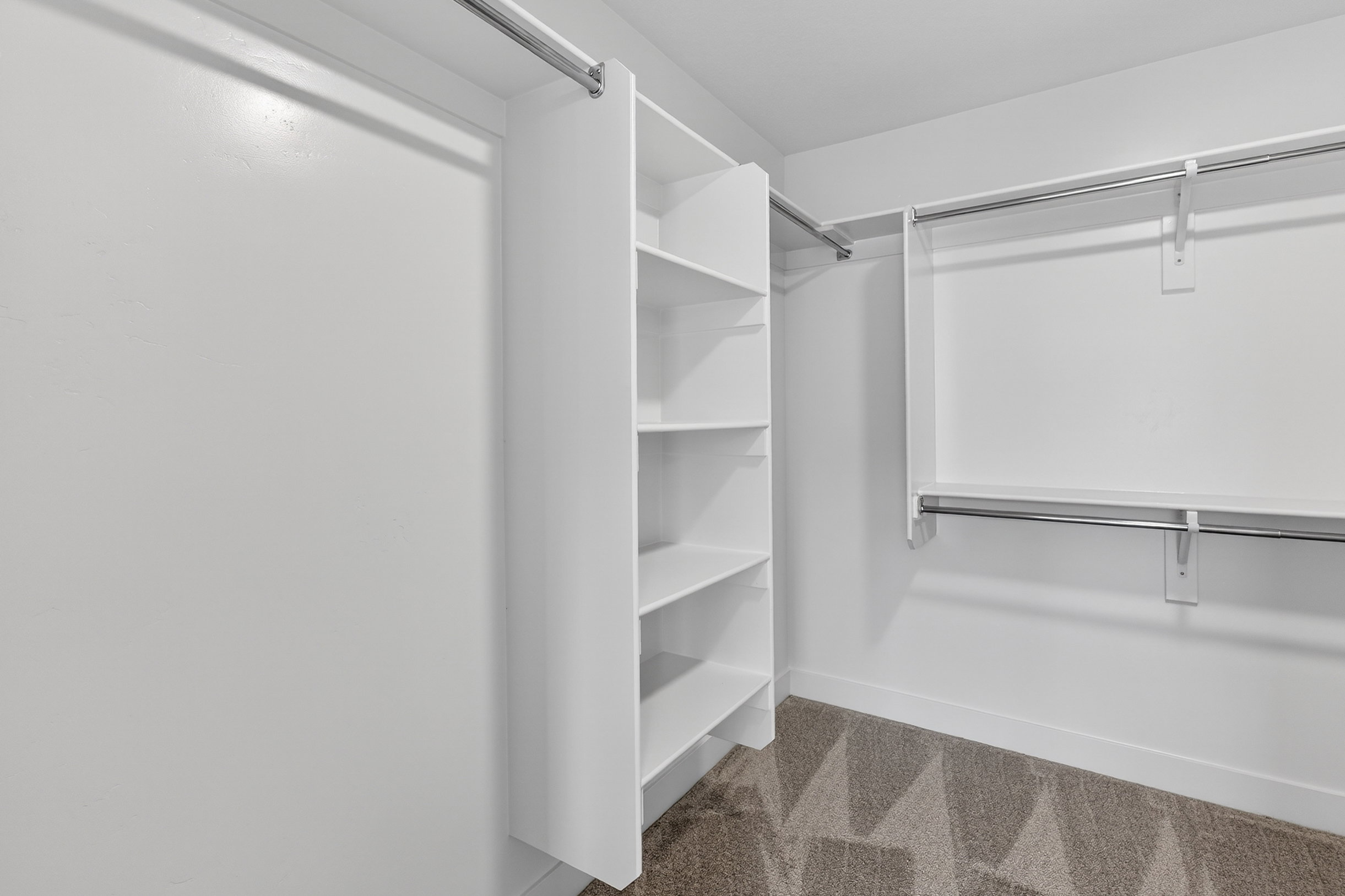 Walk in closet with light carpet