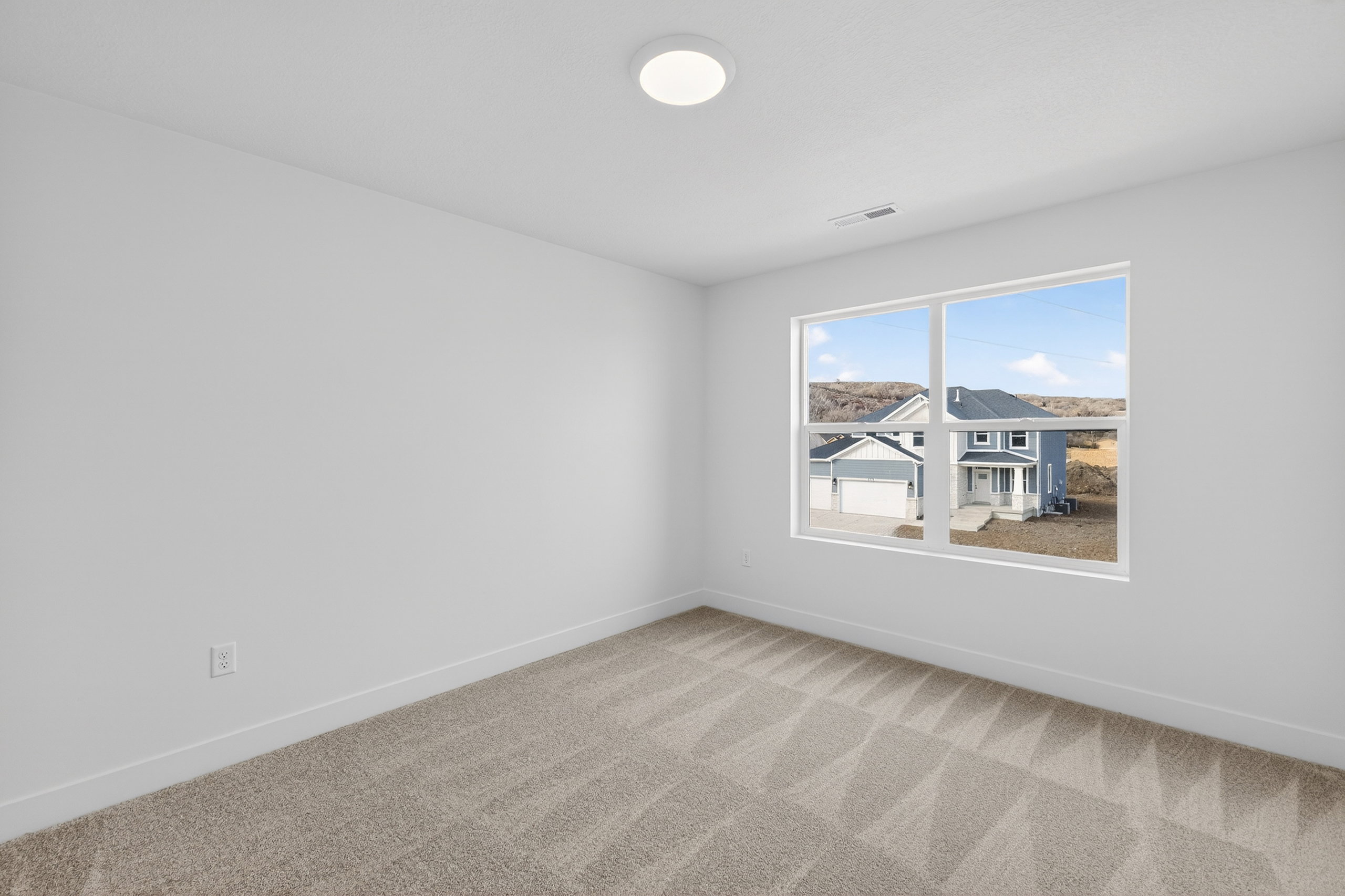 Carpeted spare room with baseboards