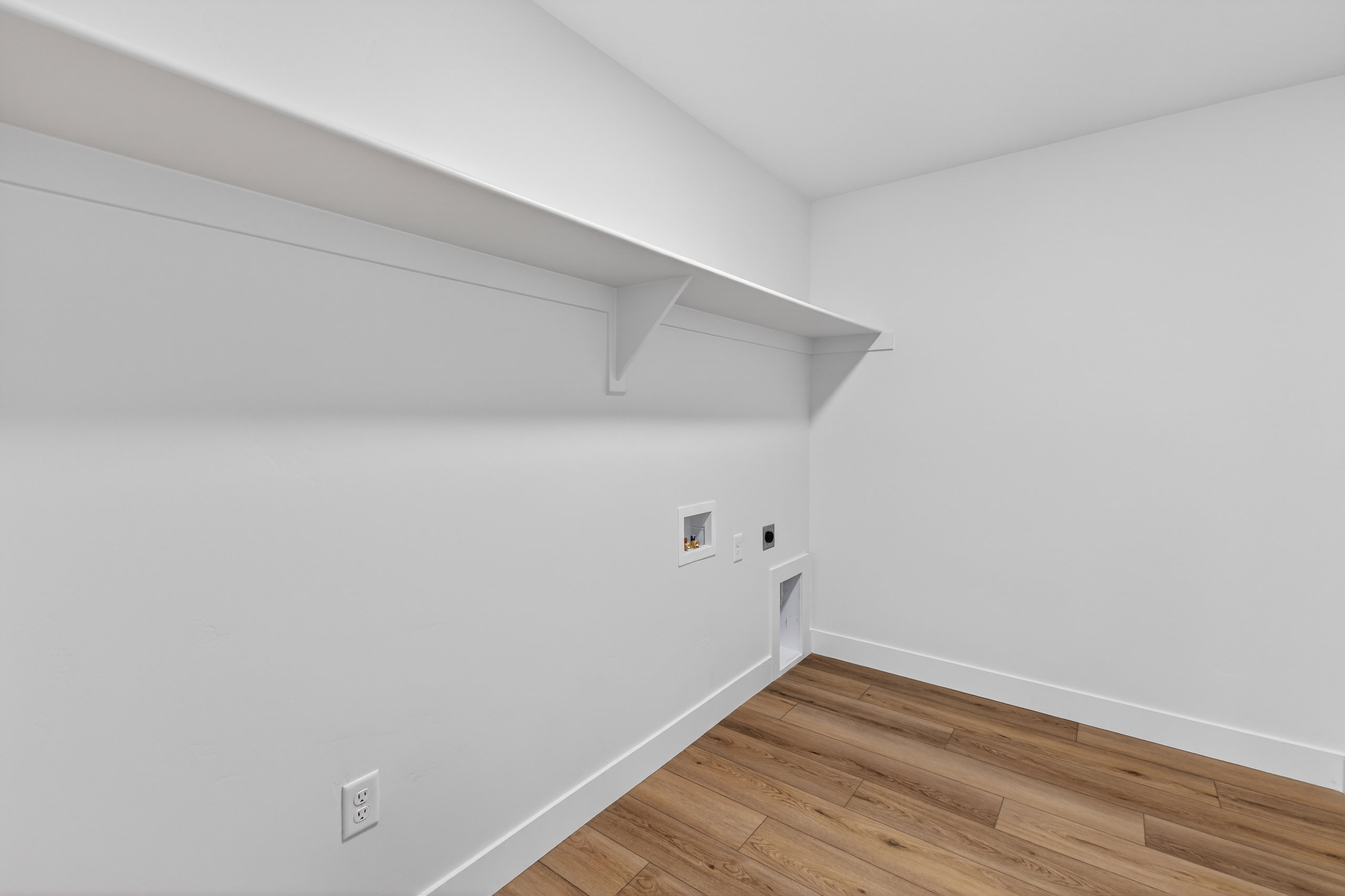 Laundry room with light wood-type flooring, hookup for an electric dryer, and washer hookup