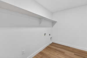 Laundry room with light wood-type flooring, hookup for an electric dryer, and washer hookup