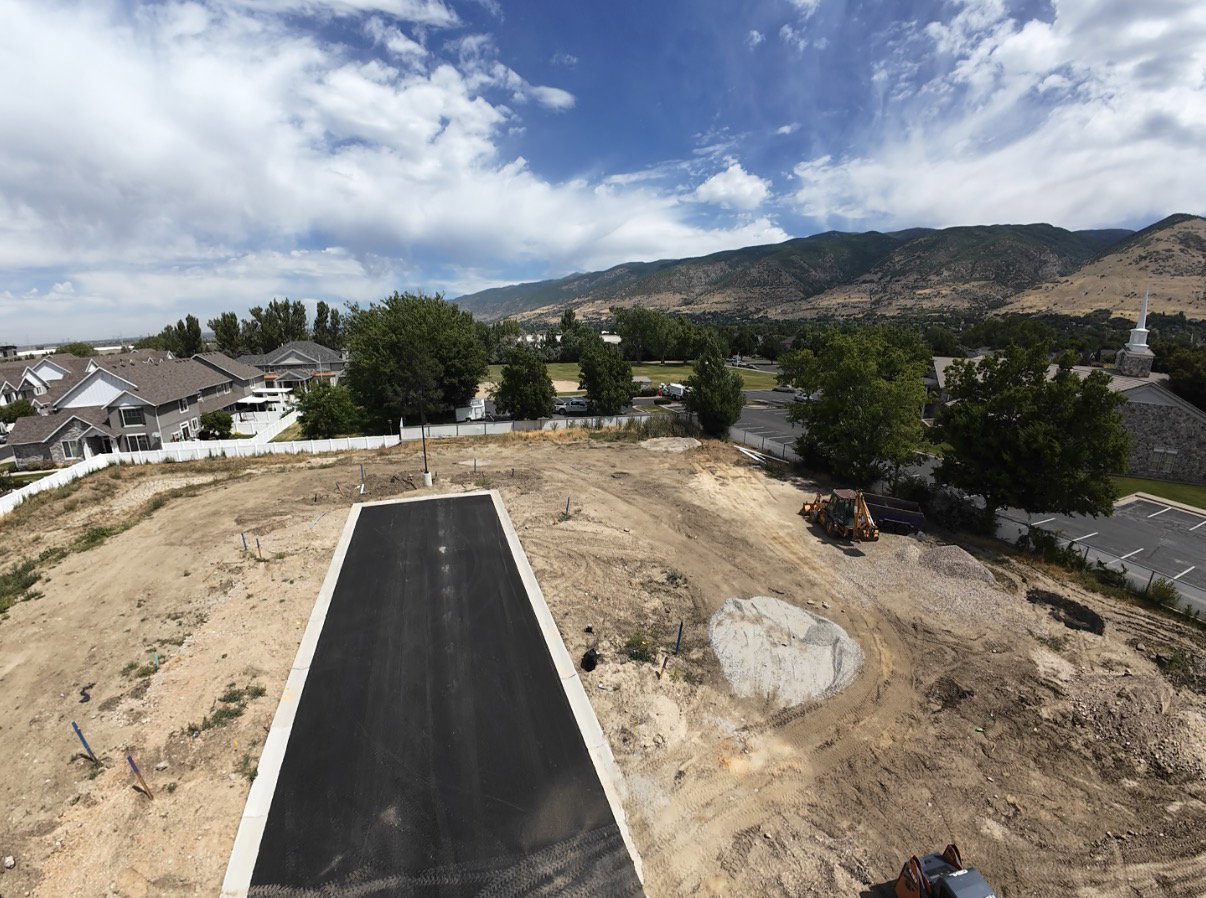 Graded lot with a paved driveway and mountain backdrop