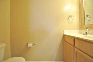 Half Bathroom featuring vanity and toilet