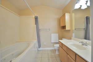 Primary Bathroom with vanity, light tile flooring, and a combined bath / shower with soaker jetted tub