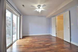 Primary bedroom with ceiling fan and wood-style flooring