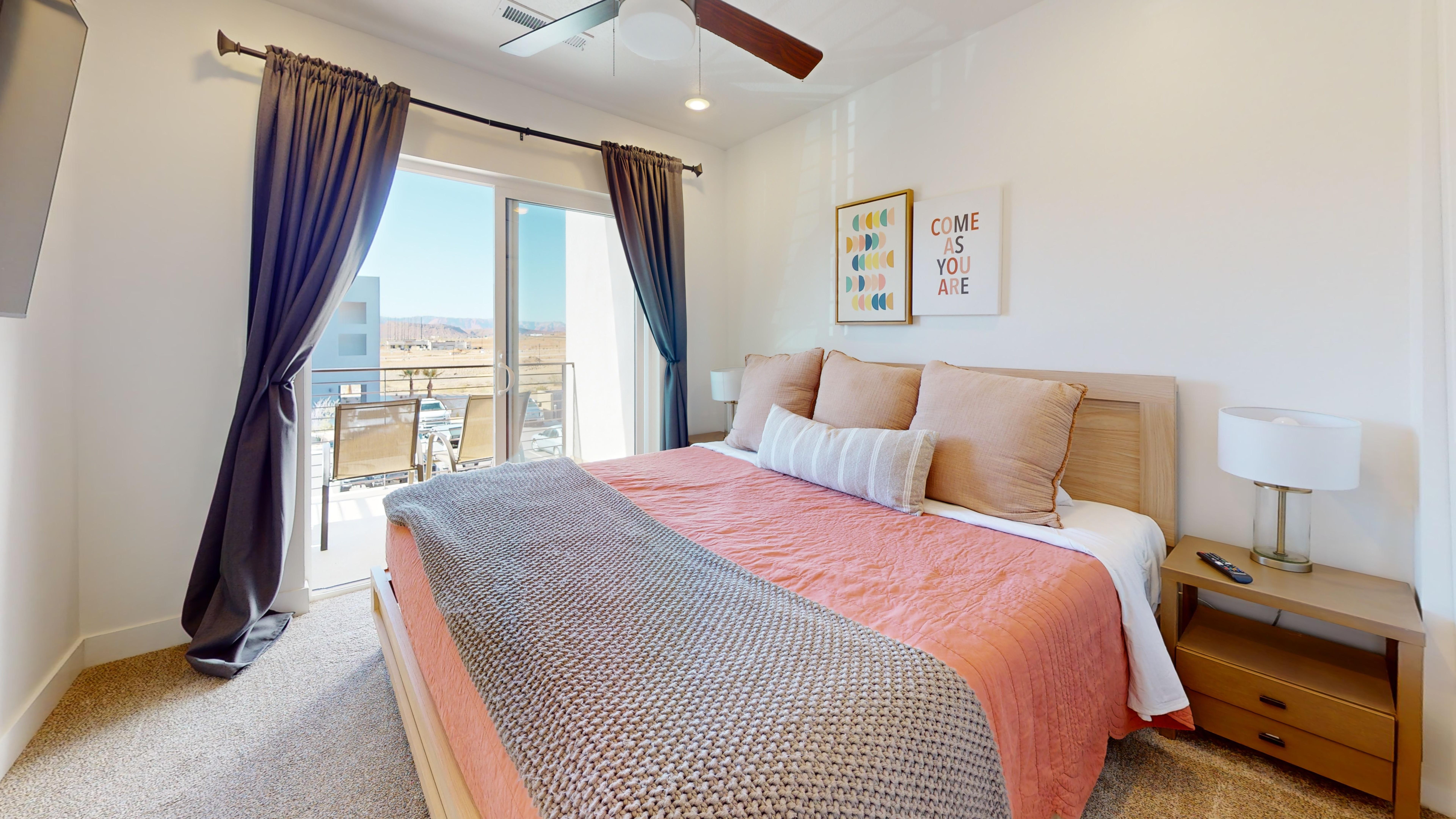 Bedroom featuring access to outside, light carpet, and a ceiling fan