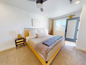 Carpeted bedroom with a ceiling fan and recessed lighting