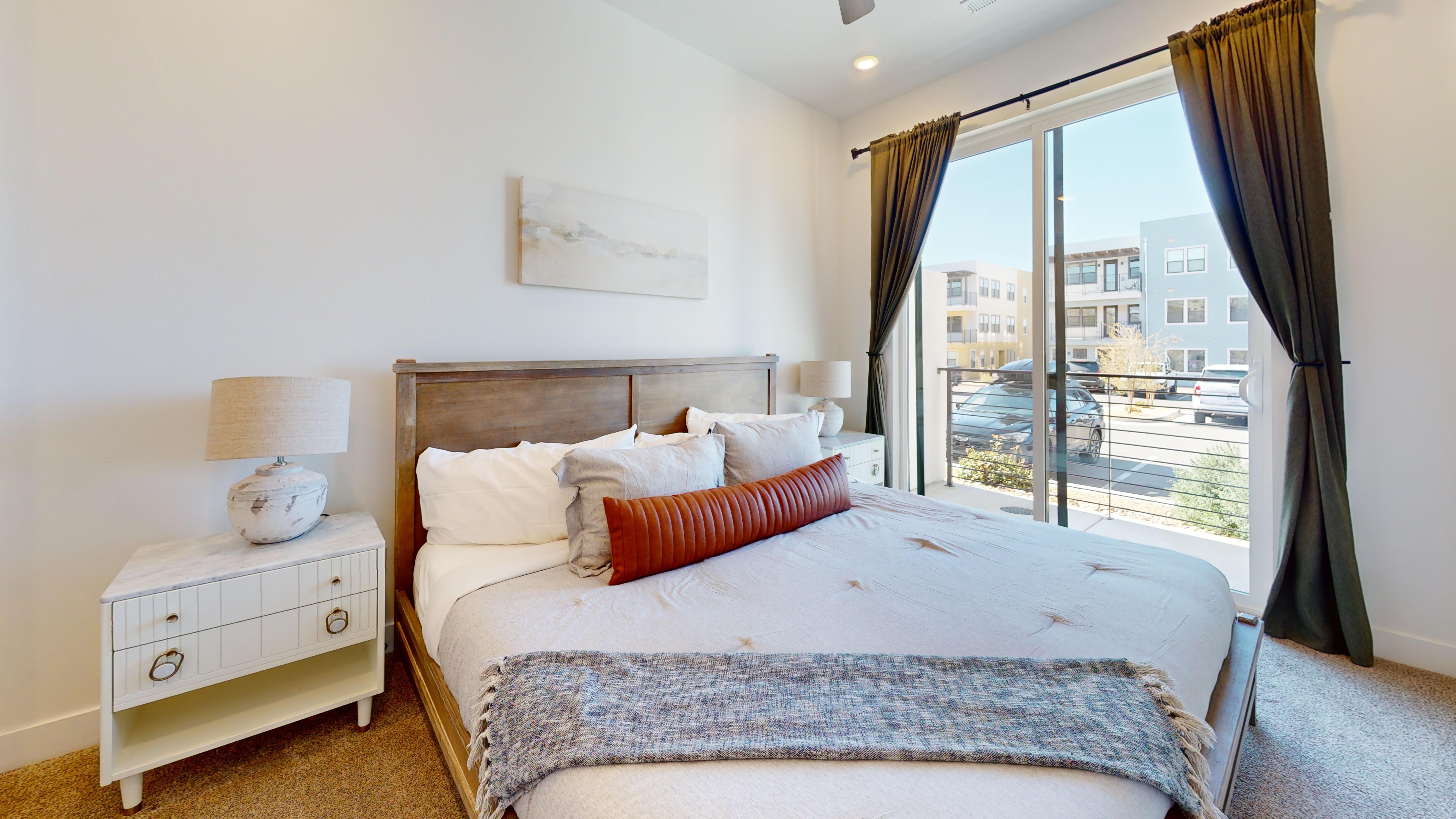 Bedroom with carpet, access to exterior, and ceiling fan