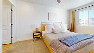 Bedroom with ceiling fan, light colored carpet, and recessed lighting