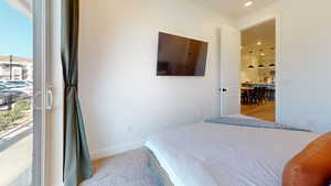 Bedroom with light colored carpet and recessed lighting