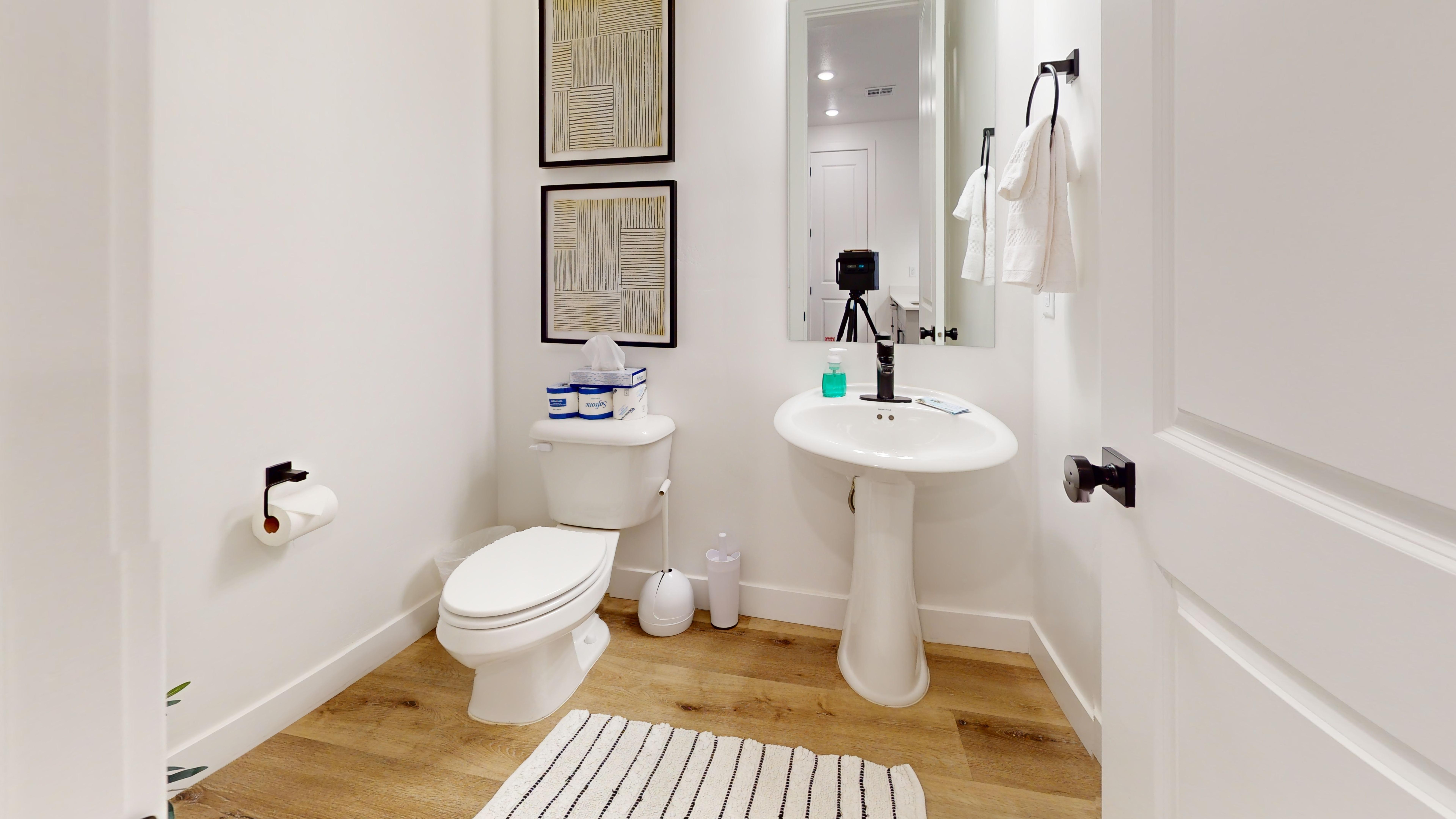 Half bathroom with light wood-style floors and recessed lighting