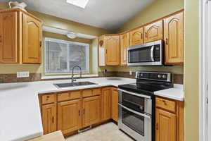 Updated kitchen showcases quartz countertops, composite granite sink (2021), and newer dishwasher & microwave (2021)