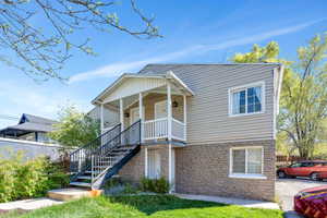 View of front of house featuring stone siding and a porch
