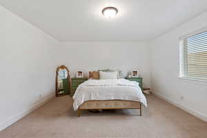 Carpeted bedroom featuring baseboards