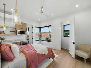 Bedroom with light wood-type flooring, beverage cooler, a ceiling fan, and recessed lighting