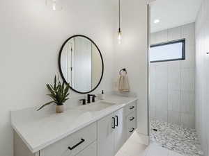 Bathroom with vanity, walk in shower, light tile patterned floors, and recessed lighting