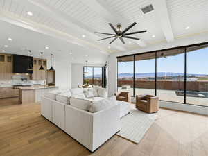 Living area with light wood-style floors, beam ceiling, a mountain view, recessed lighting, and ceiling fan