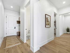 Corridor with recessed lighting and light wood-style flooring