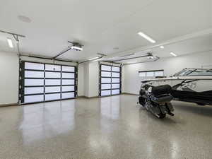 Garage featuring baseboards and a garage door opener