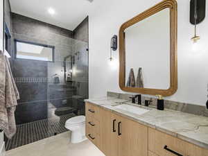 Bathroom with vanity, walk in shower, and light tile patterned floors