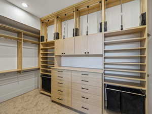 Walk in closet featuring light carpet