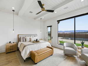 Bedroom with wood finished floors, a ceiling fan, a mountain view, recessed lighting, and beamed ceiling