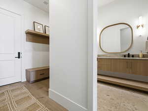 Bathroom featuring vanity and light wood finished floors