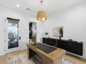 Home office featuring light wood-type flooring and recessed lighting