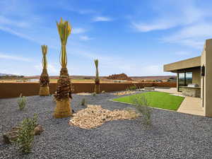 Fenced backyard featuring a patio and exterior kitchen