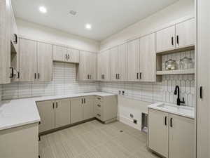 Laundry area featuring cabinet space, hookup for a washing machine, hookup for a gas dryer, recessed lighting, and electric dryer hookup