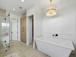 Full bathroom featuring a soaking tub, a shower stall, concrete floors, and recessed lighting