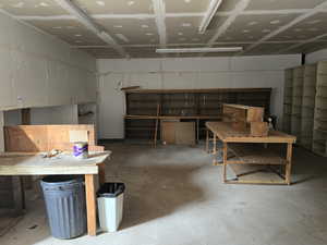Misc room featuring a workshop area and concrete floors