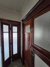 Doorway to outside with crown molding